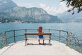 Woman relaxing on a bench in Bellagio, Lake Como, Italy.